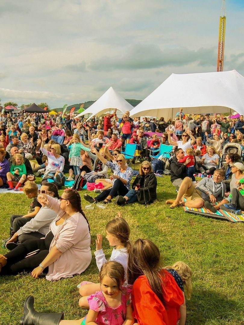 crowd sat on grass.