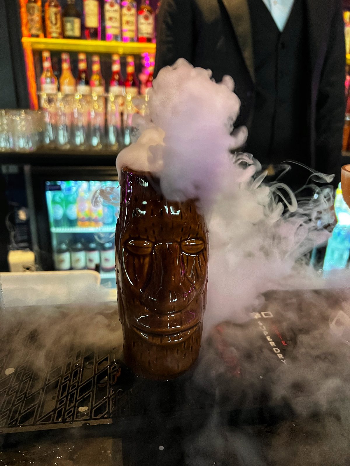 smoking dry ice cocktail in Tiki glass.