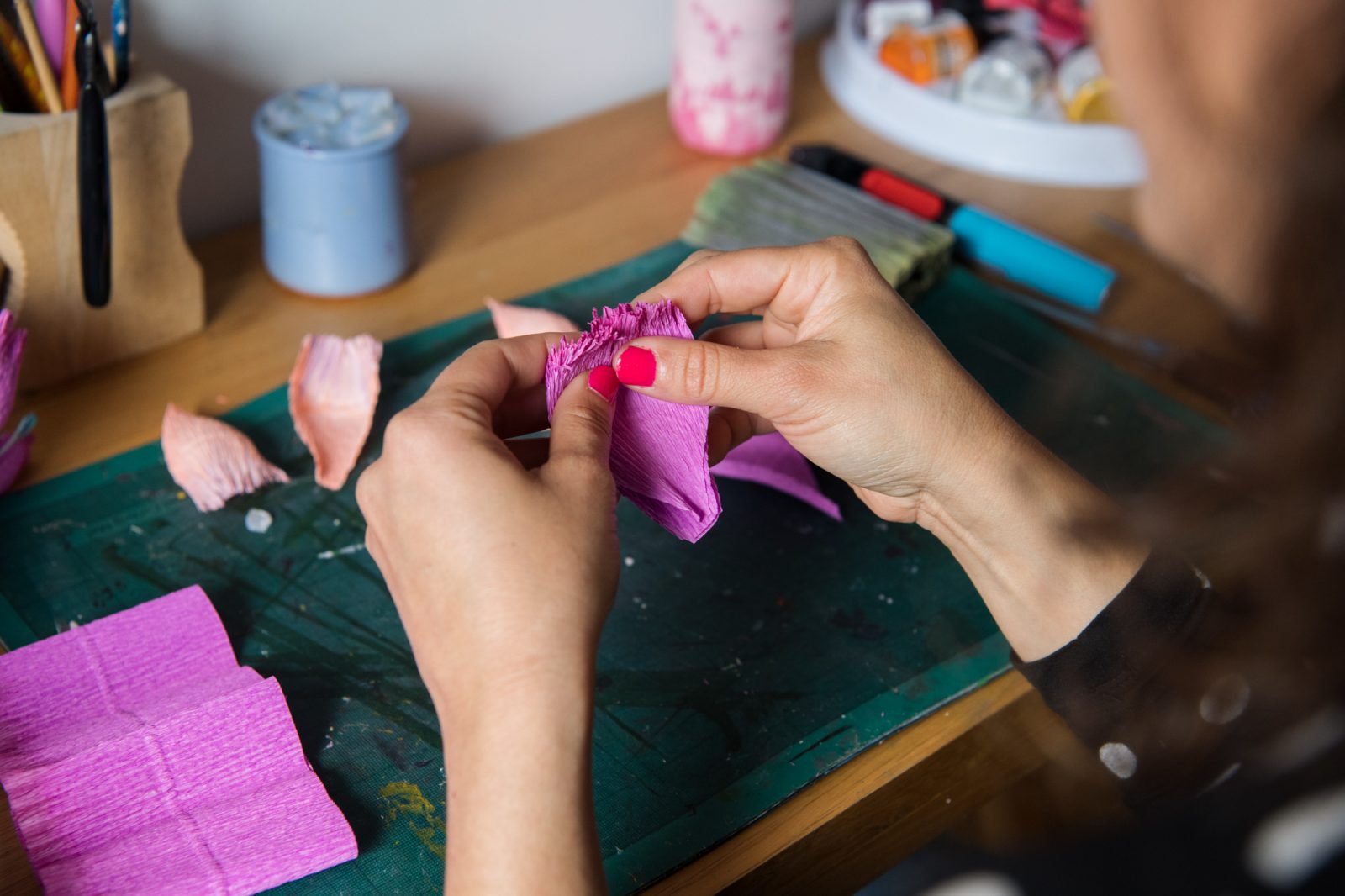 A person making a paper flower. 