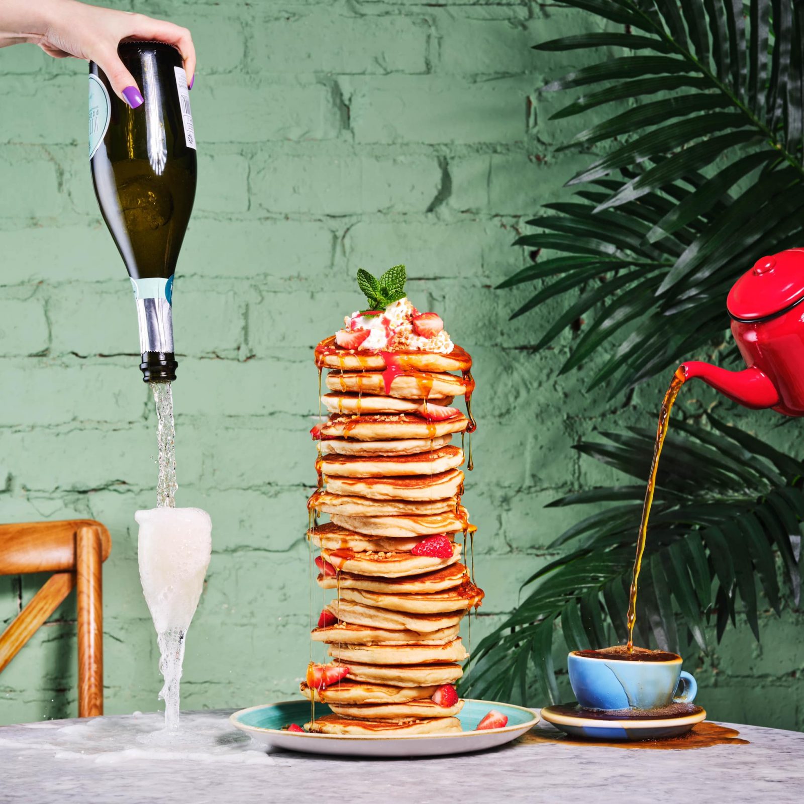 A huge stack of Pancakes and a bottle of prosecco. 