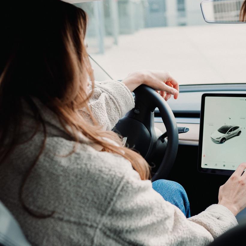 A woman driving a taxi. 