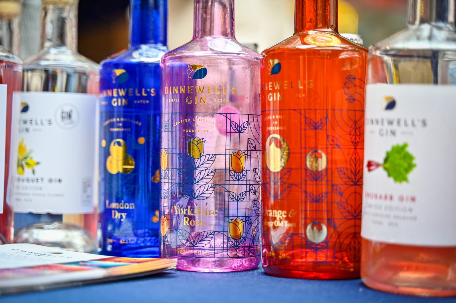 A selection of brightly coloured gin bottles. 