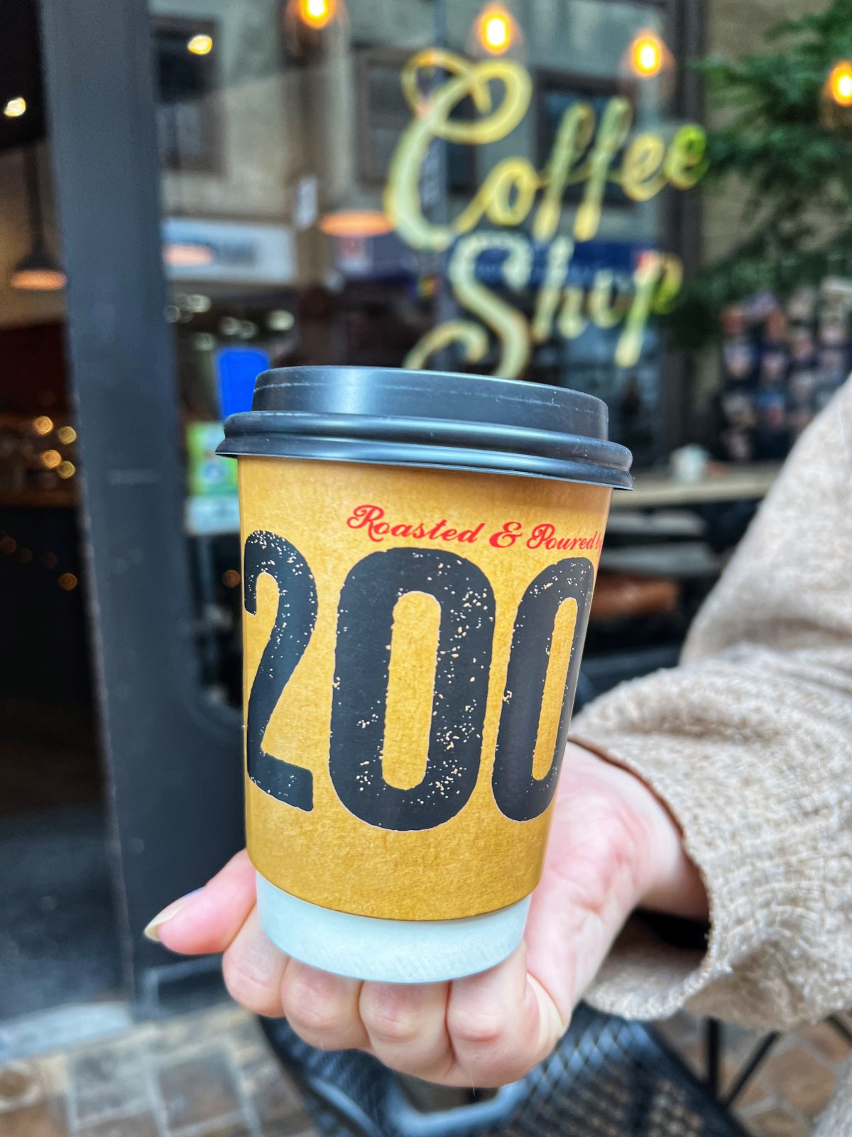coffee cup with 200 written on the front.