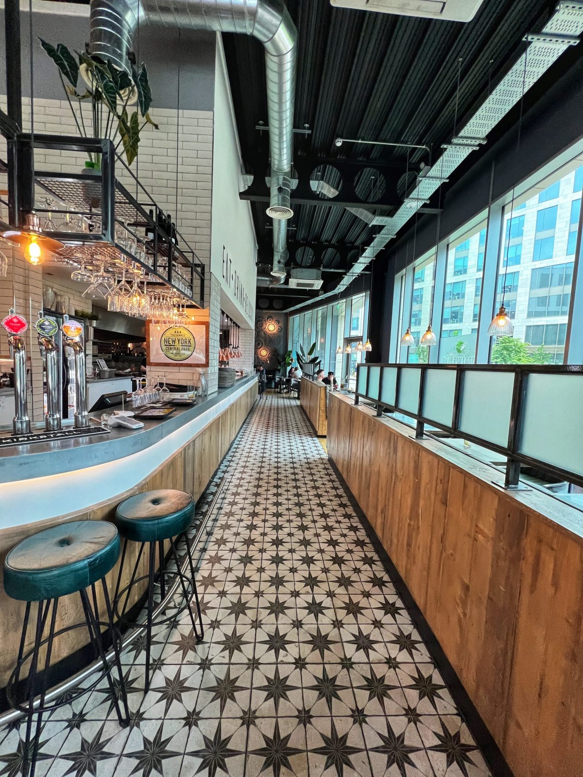 restaurant with checker board flooring and blue bar stools.