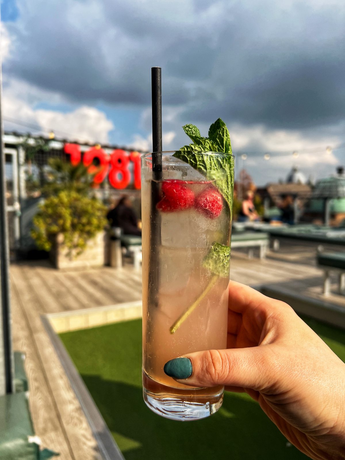 A pink cocktail on a rooftop.
