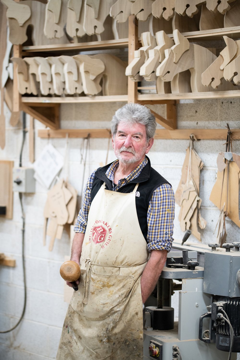A man with an apron in a workshop. 