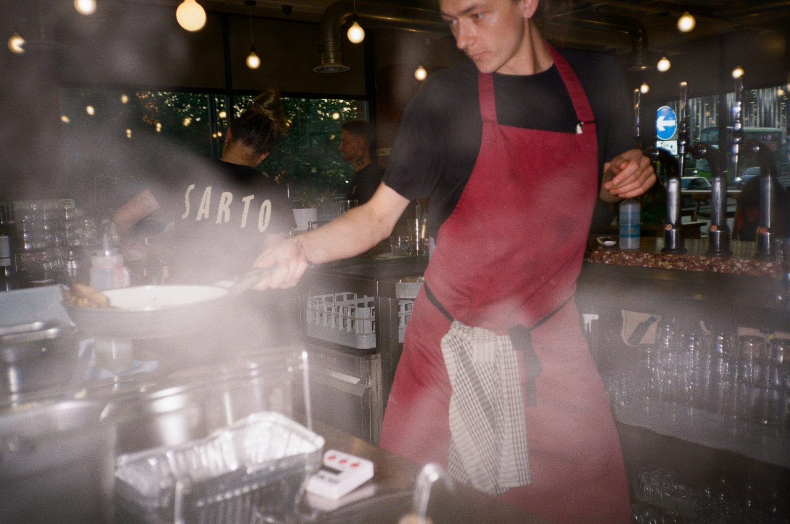 person cooking a dish with a pan in their hand.