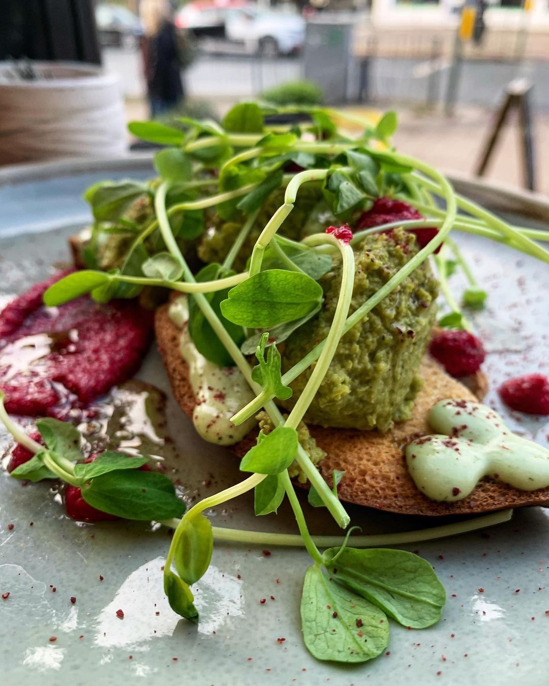 pea on toast with rocket on top.