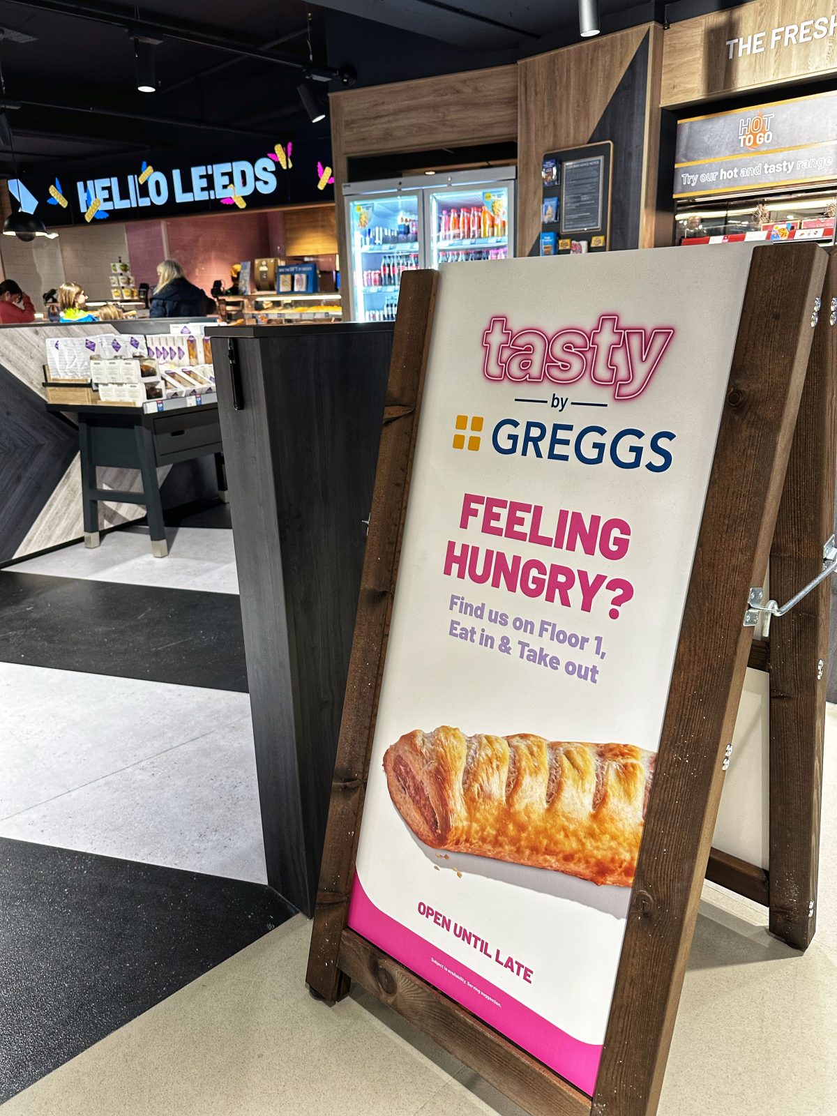 A sign that says 'Tasty by Greggs'