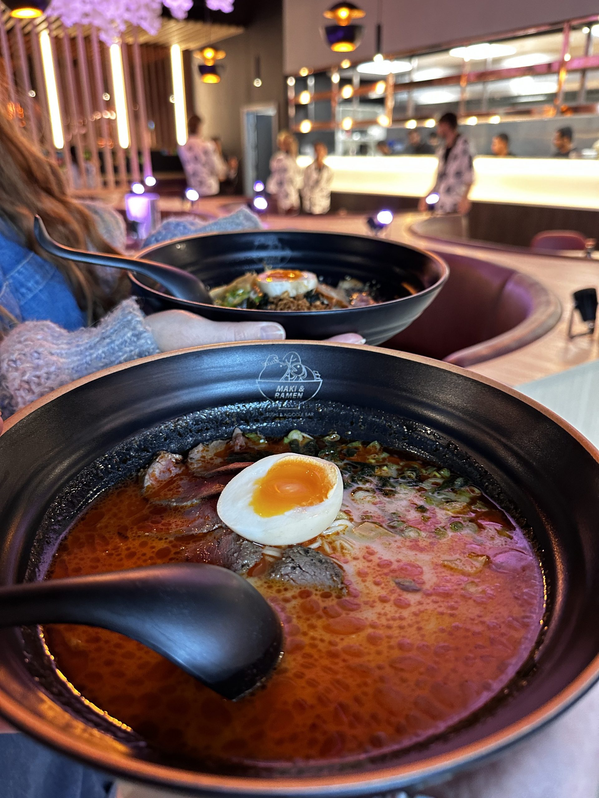 A spicy ramen with half an egg on top. 