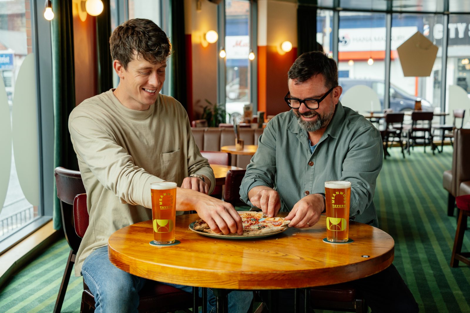 two people eating pizzas.