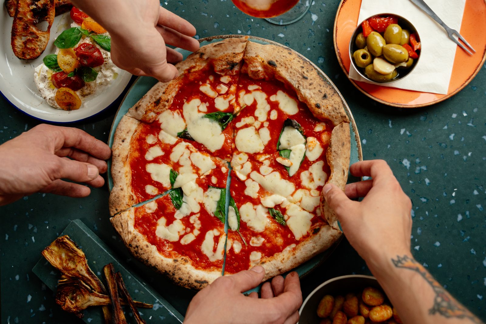 two people eating a pizza.