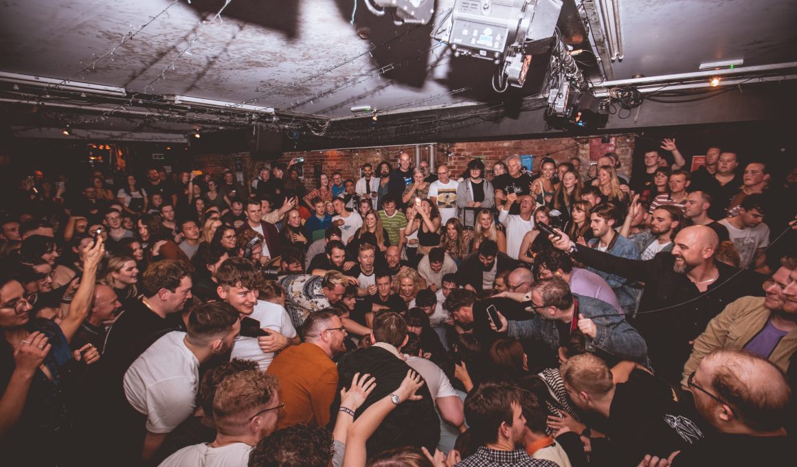 crowd singing at a festival.