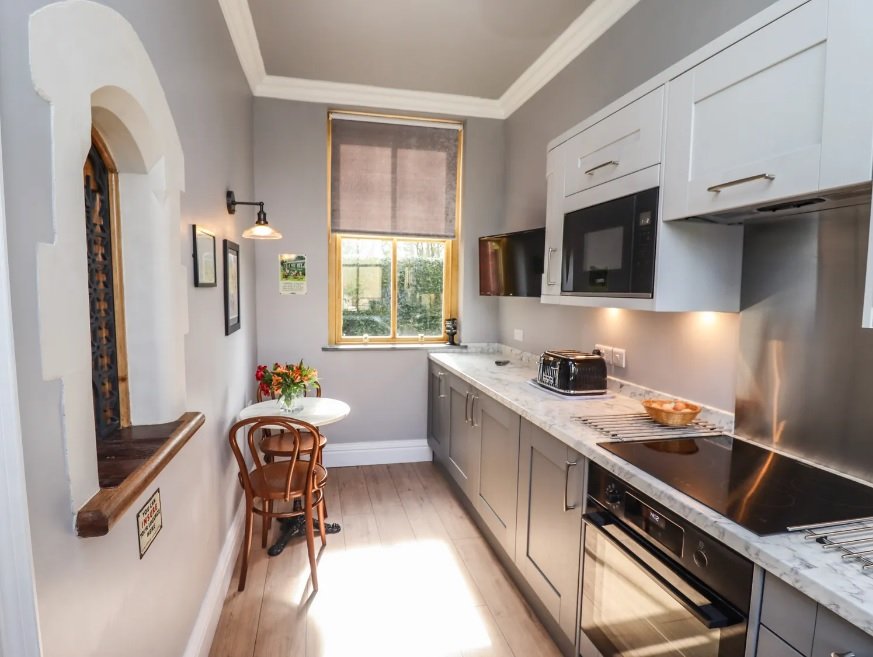 kitchen with wooden table and chair in the corner.