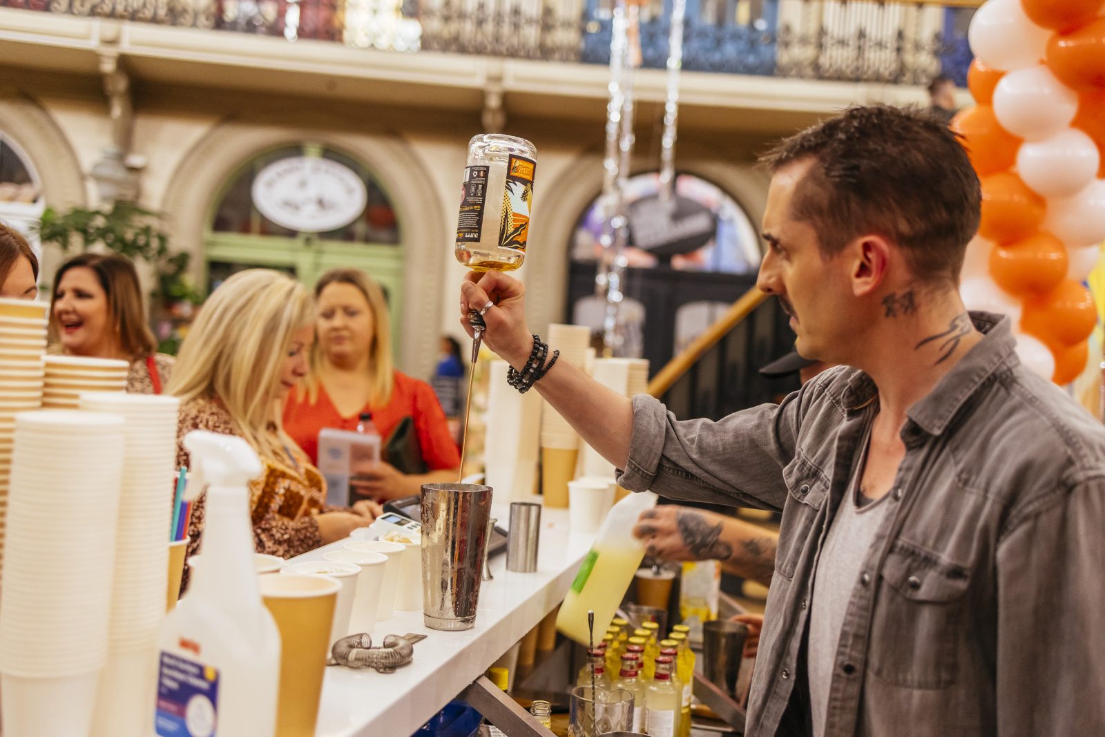 A man pouring rum at Leeds Rum Festival. 
