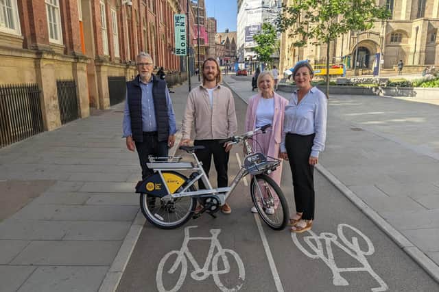 Four people standing behind an e-bike in Leeds. 