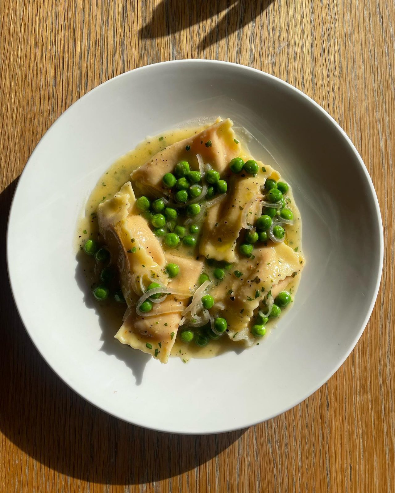 A plate of pasta with peas. 
