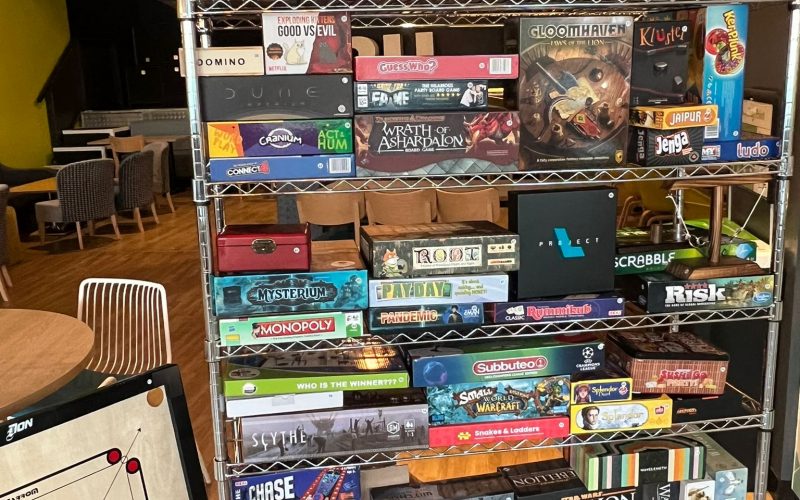 lots of board games stacked in a row.