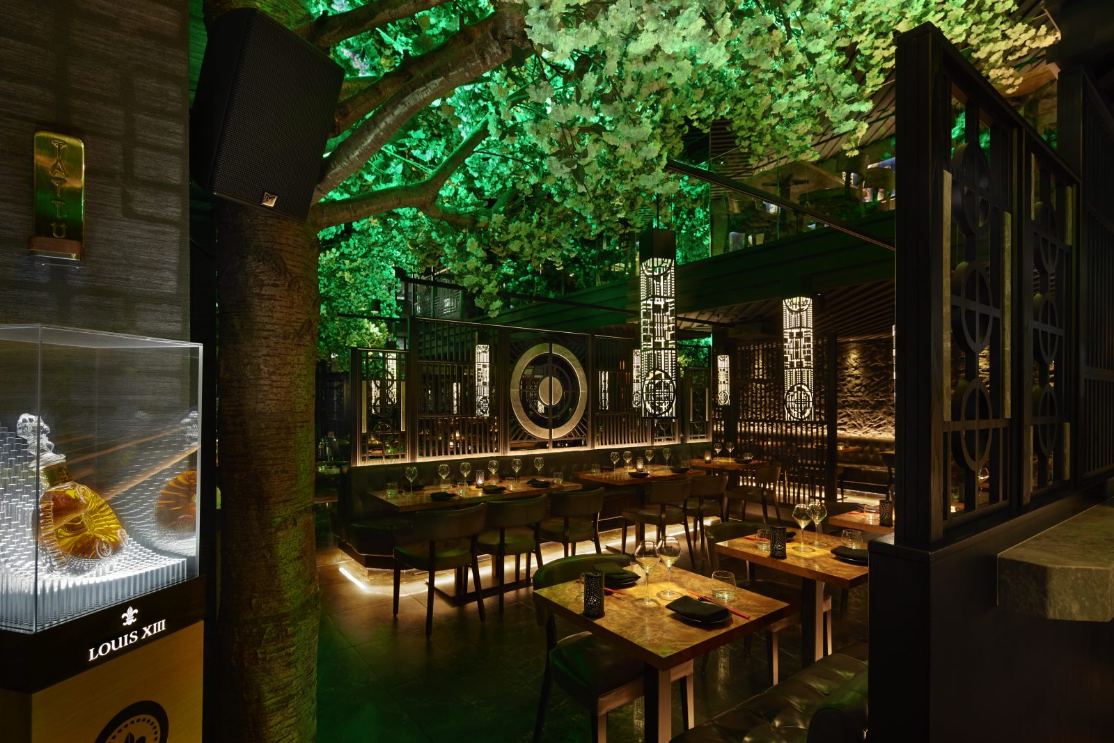 The interior of Tattu in Leeds with green blossom trees. 