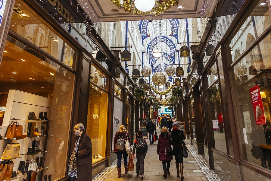 people walking through arcade.