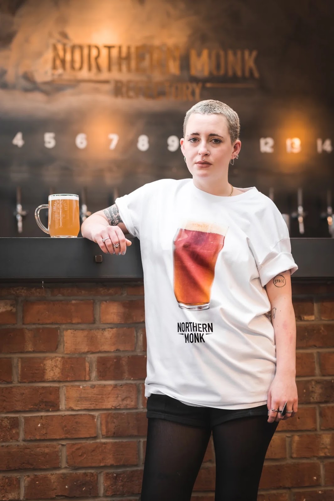 person in a beer t-shirt holding a beer.