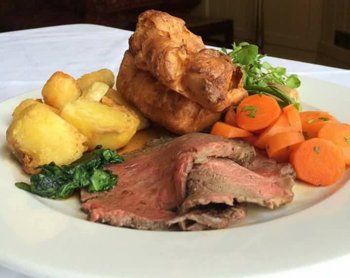 roast dinner plate with beef and carrots.