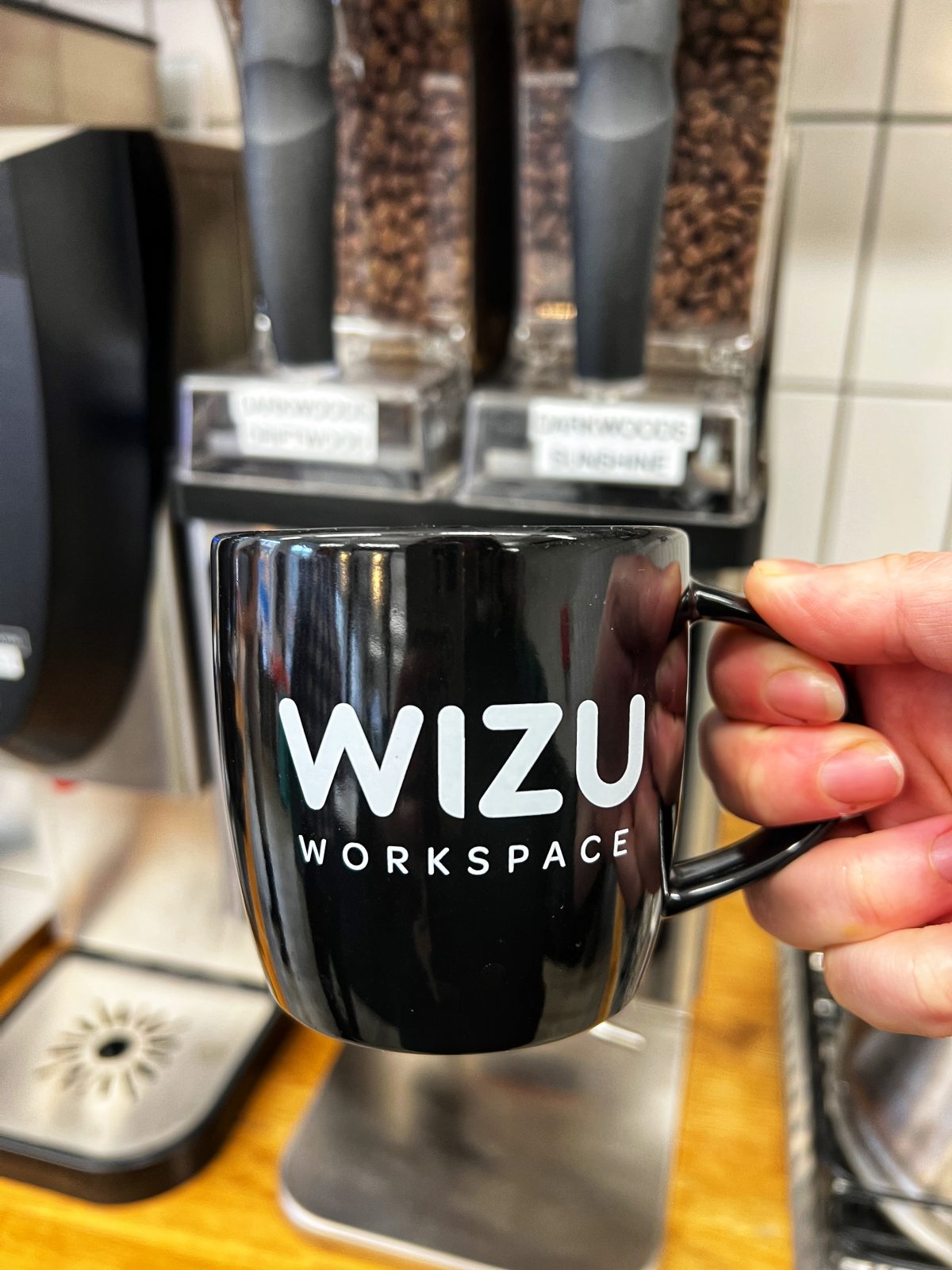A black mug from Wizu Workspace. 