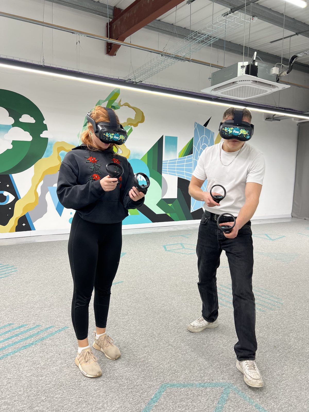 A man a woman playing a VR game.