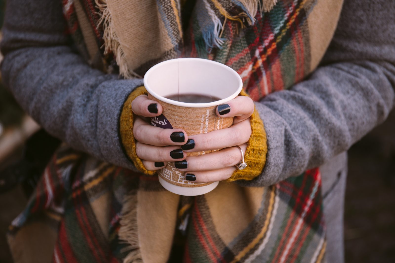 A woman holding a mug of mulled wine. 