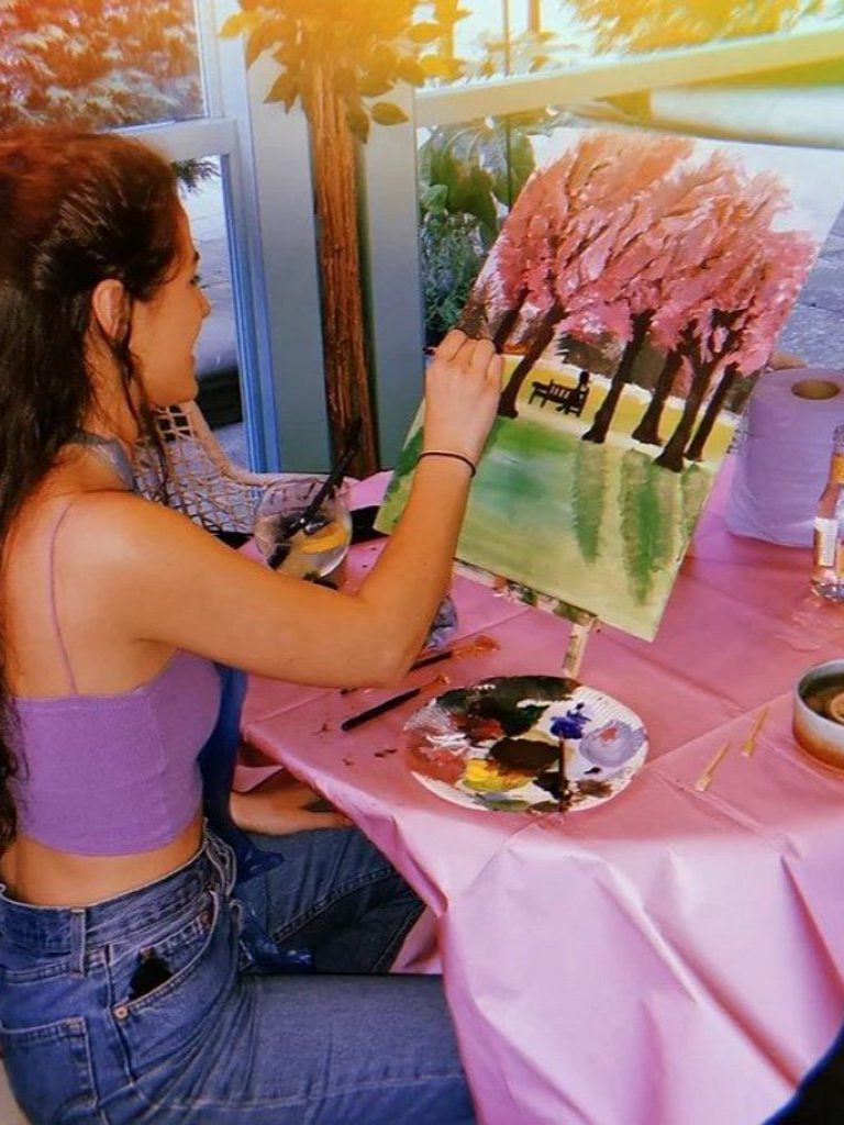 person painting trees.