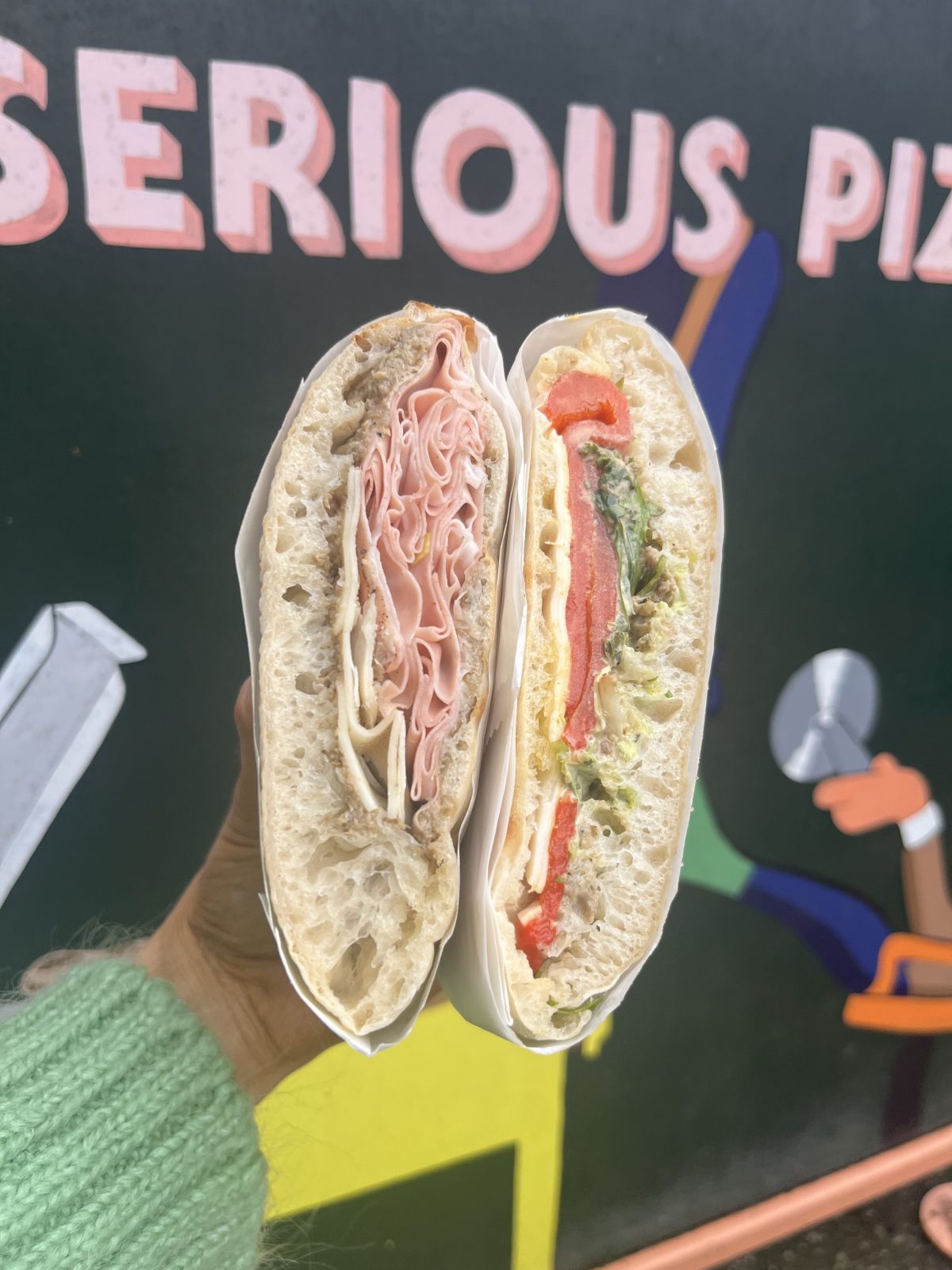 pizza sandwich held up to the camera.