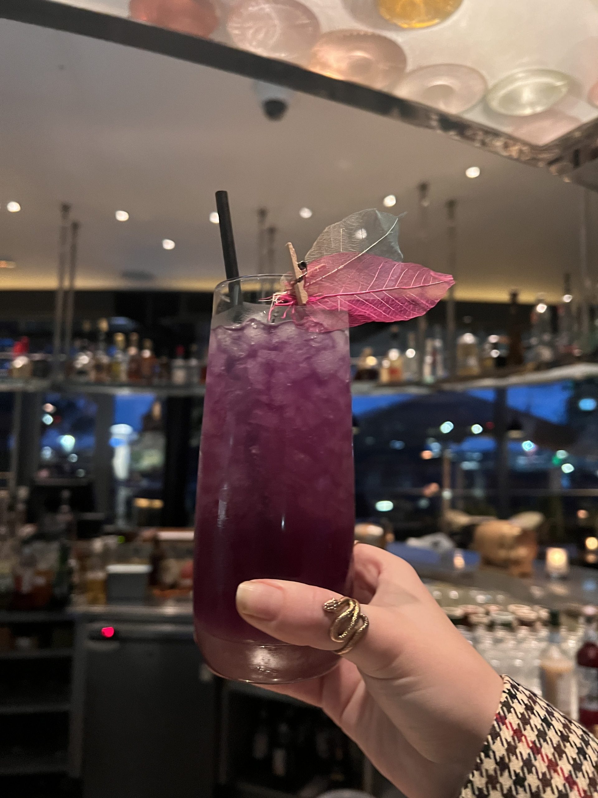 purple cocktail with straw.