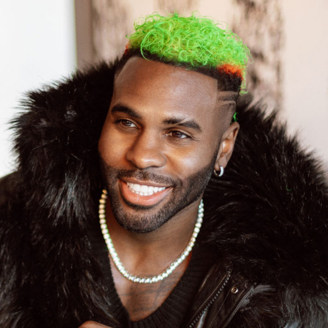Jason Derulo in feather coat with green hair.