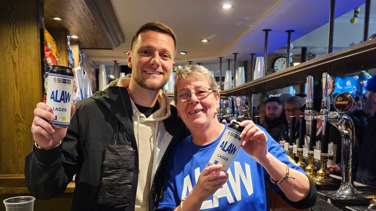 Liam Cooper puts £1k in free drinks behid the bar at The Old Peacock pub in Leeds