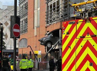 Large cordon in place after vehicle crashes through wall and dangles over Leeds street