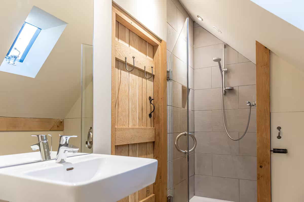 The living space and en-suite bathroom at Chequer Barn Apartment / Credit: Airbnb (via Supplied)